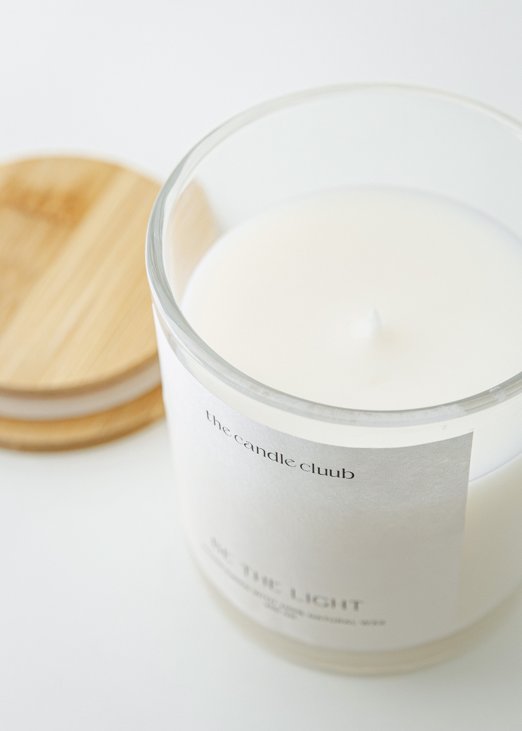 Classic Cluub Candle in the scent Creamy Coconut made from soy and coconut wax featured in glass jar with bamboo lid
