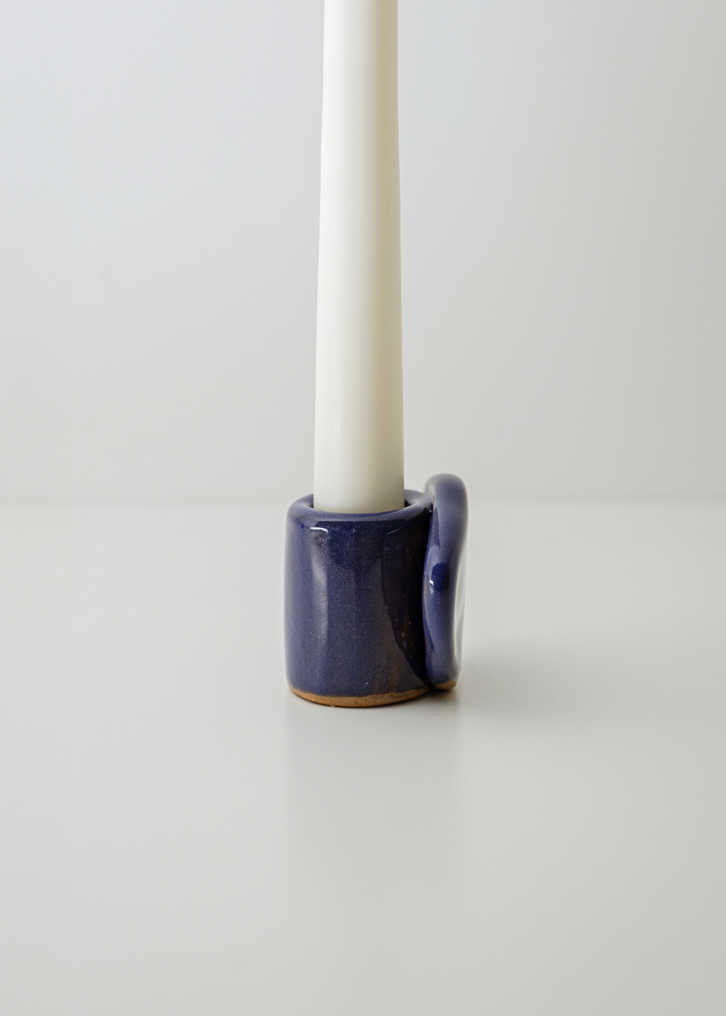 
From Light to Table white taper candle holder set with textured ceramic surface and napkin holder function