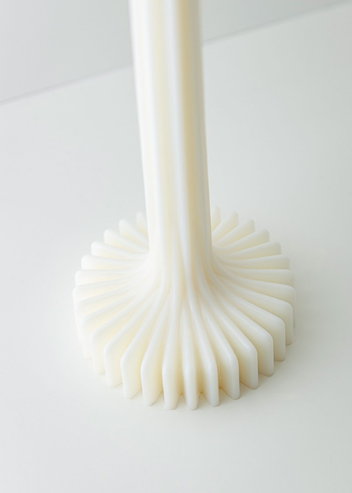 Incontro candle base white soy and coconut wax candle with a ribbed design on a light background