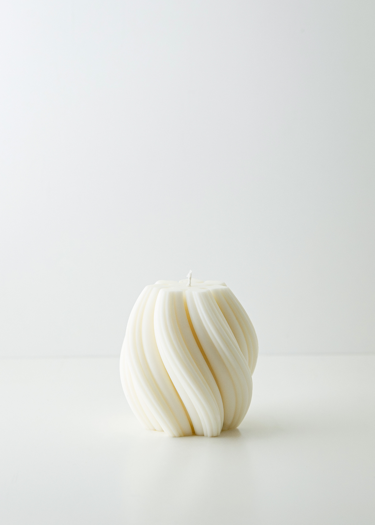 Seta white soy and coconut wax candle by The Candle Cluub with smooth ribbed wax and twirling flame effect