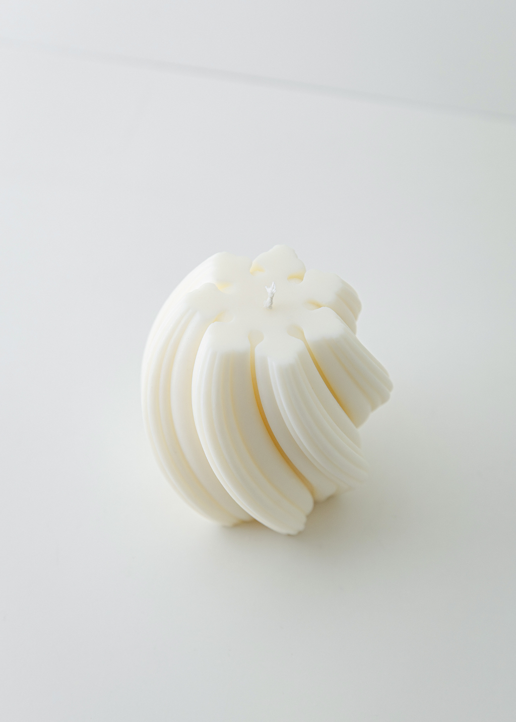 Seta white soy and coconut wax candle by The Candle Cluub with smooth ribbed wax and twirling flame effect