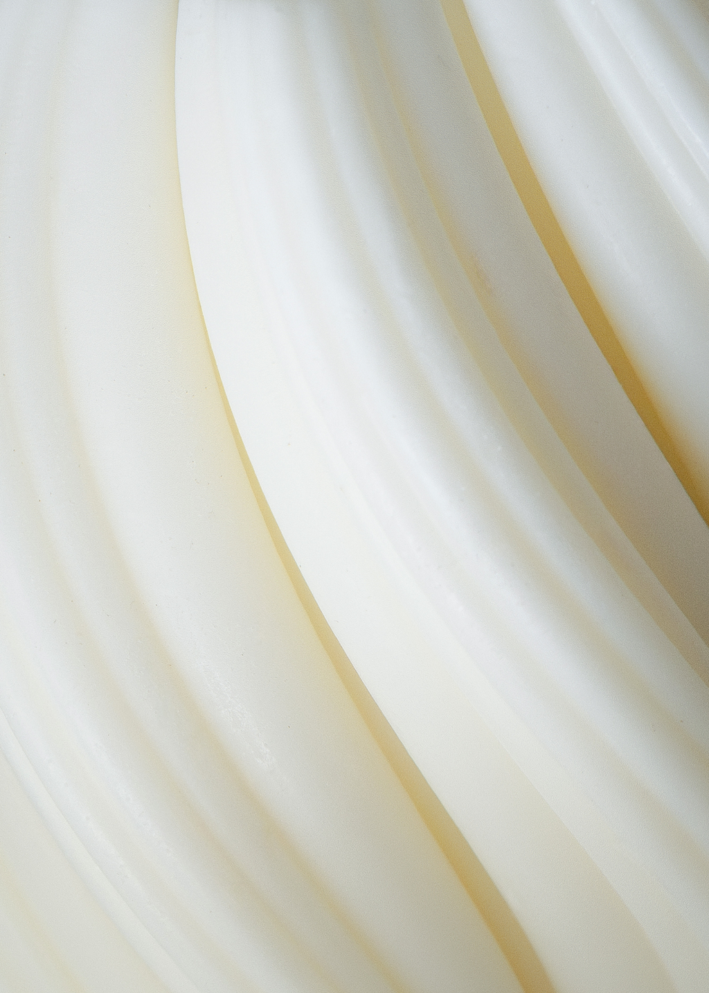 Seta white soy and coconut wax candle by The Candle Cluub with smooth ribbed wax and twirling flame effect close up