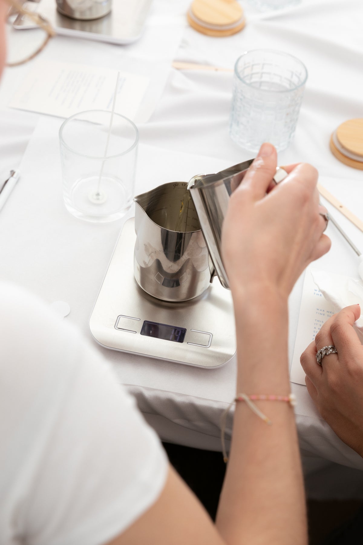 Create your candle Workshop stainless steel candle pouring jug on a white workshop table